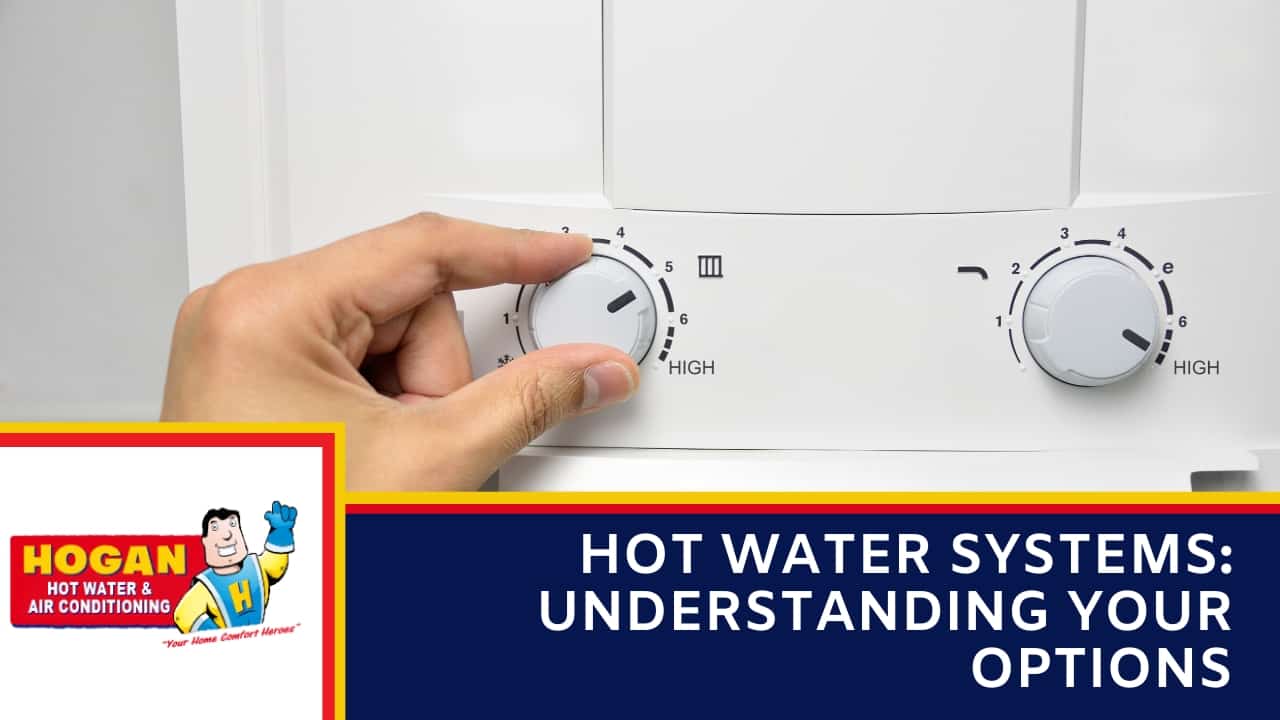 A close-up of a hand adjusting a white temperature dial on a hot water unit control panel.