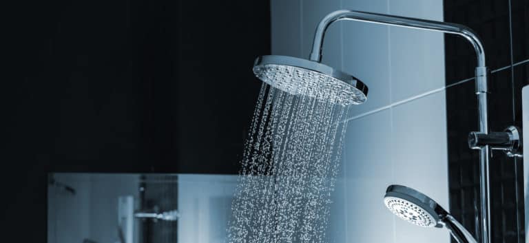Water flowing from shower in the bathroom interior