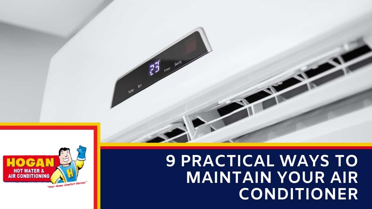 A close-up, angled view of a white split-system air conditioning unit with its digital display showing 23 degrees.