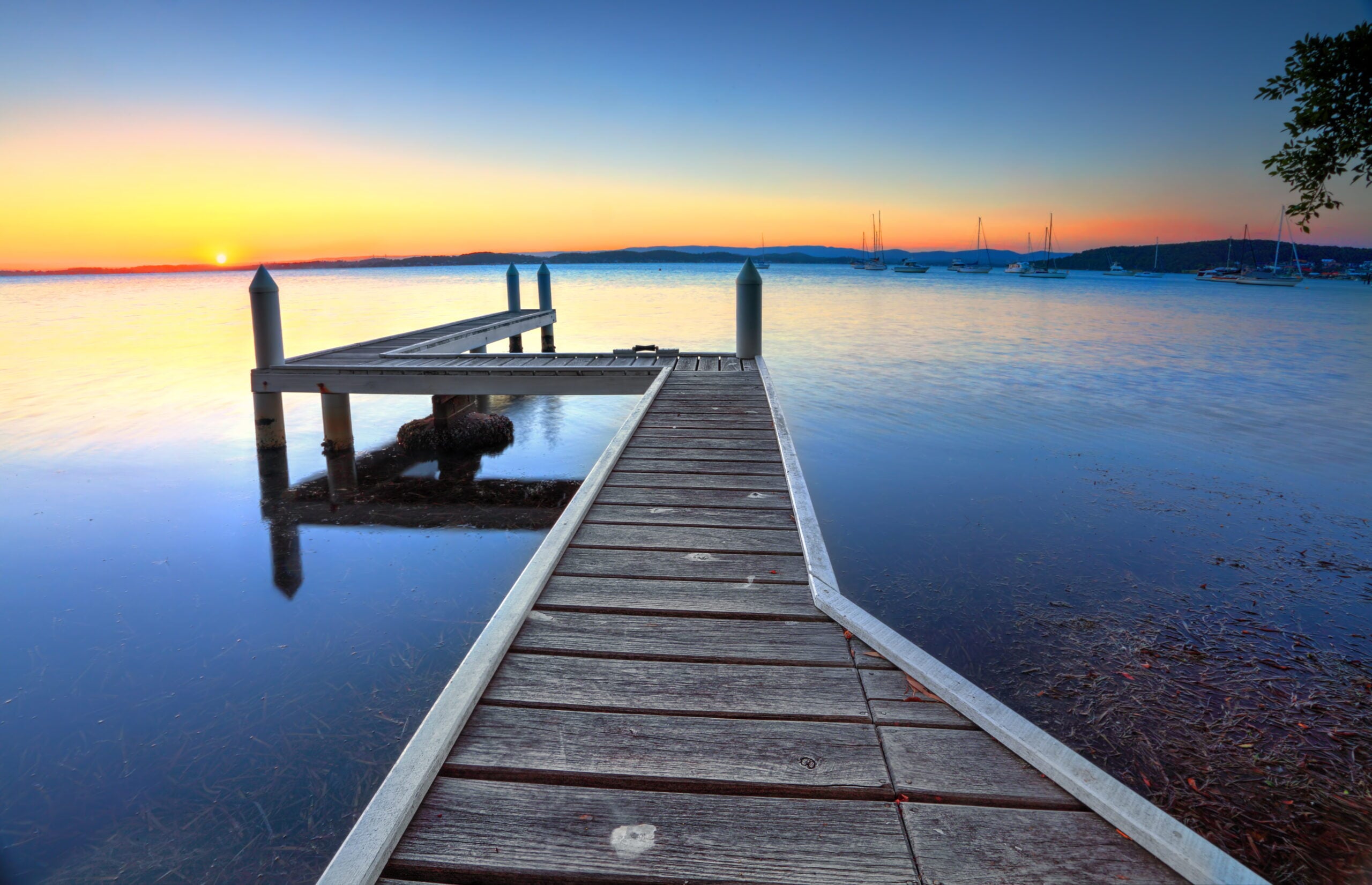 A wooden jetty extending into a calm lake in Belmont