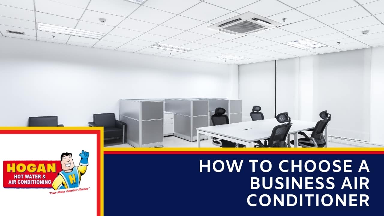 A brightly lit, modern office space with white cubicles