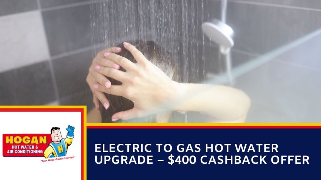 A person washing their hair in a running shower.