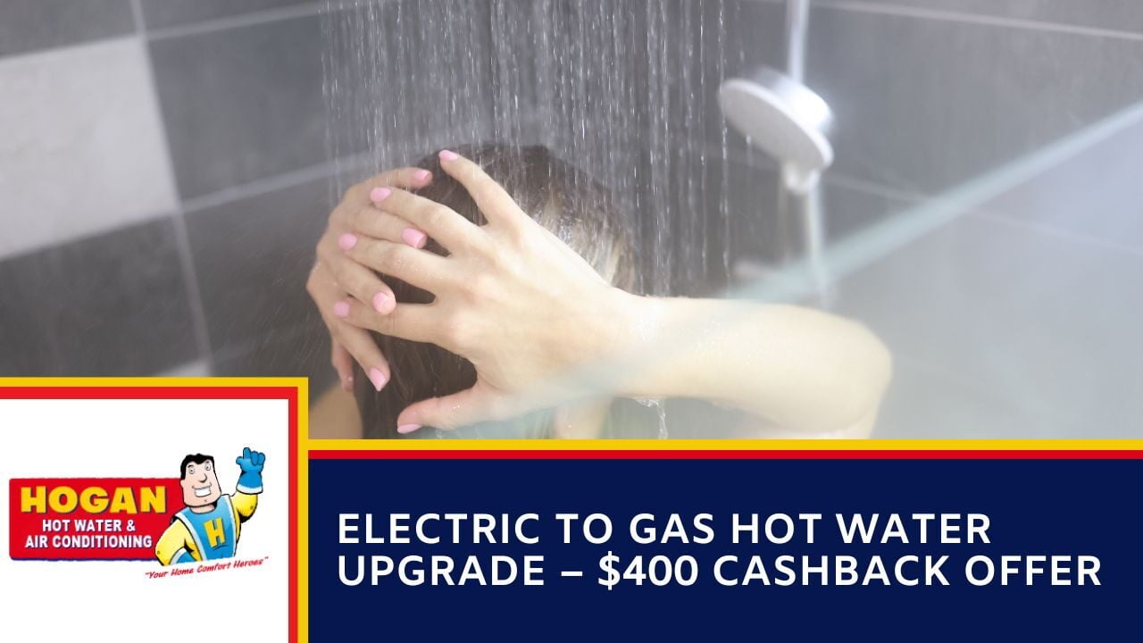 A person washing their hair in a running shower.