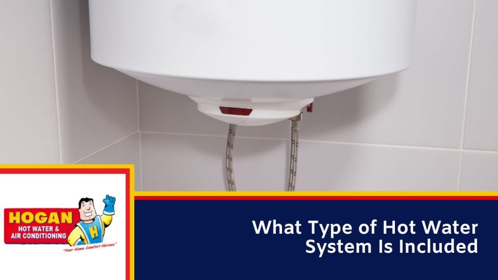 A close-up view of the bottom of a white wall-mounted water heater with flexible hoses.