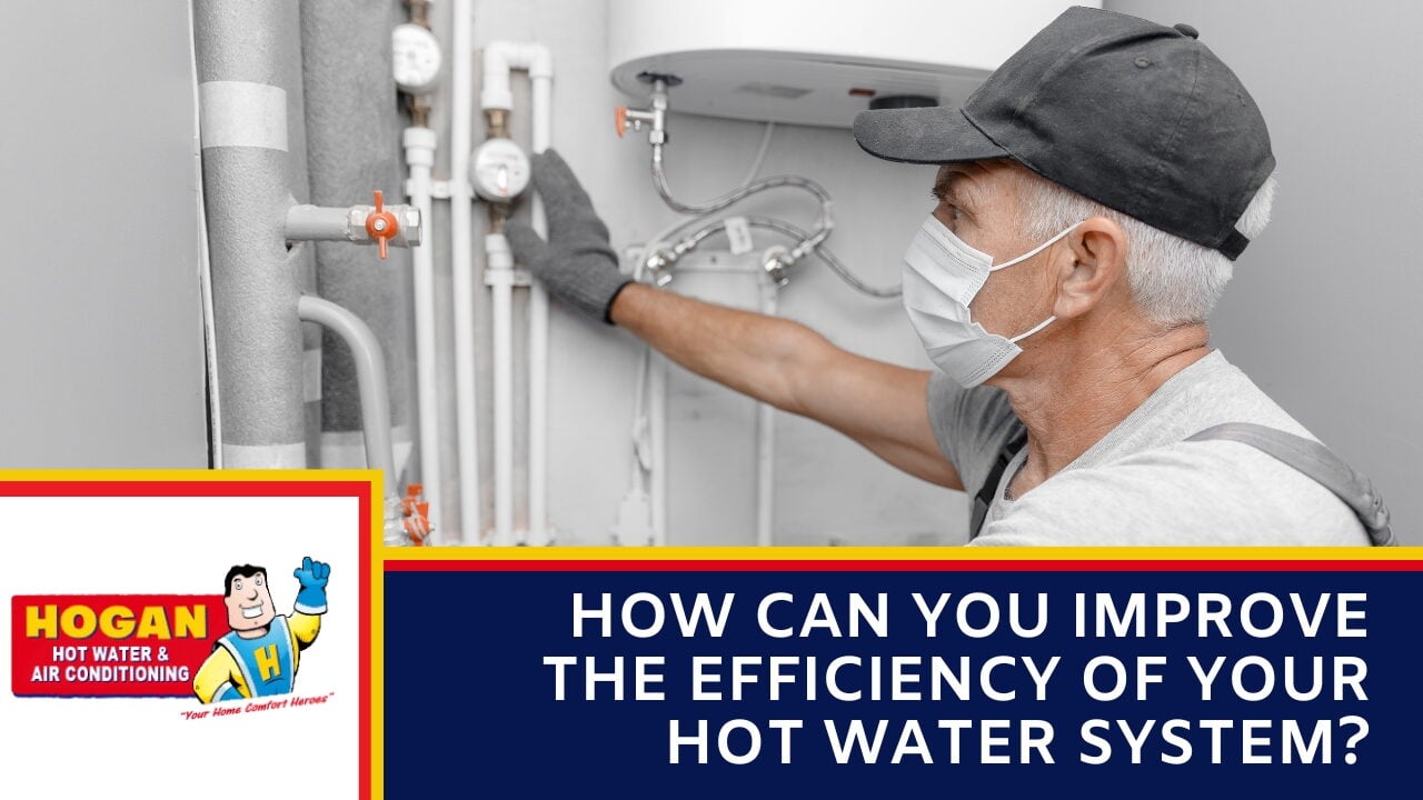 A technician in a face mask and cap inspecting a water heater system.