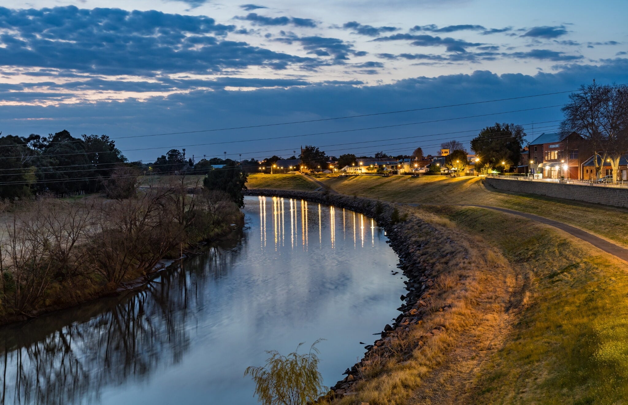 A tranquil evening view of a river winding through a town in Australia.
