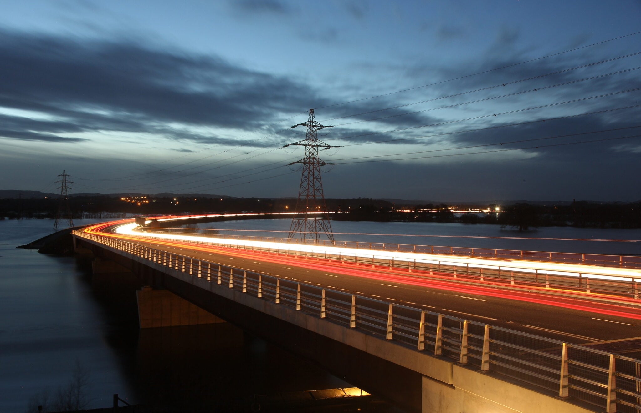 A long-exposure evening photograph of a multi-lane bridge in Australia