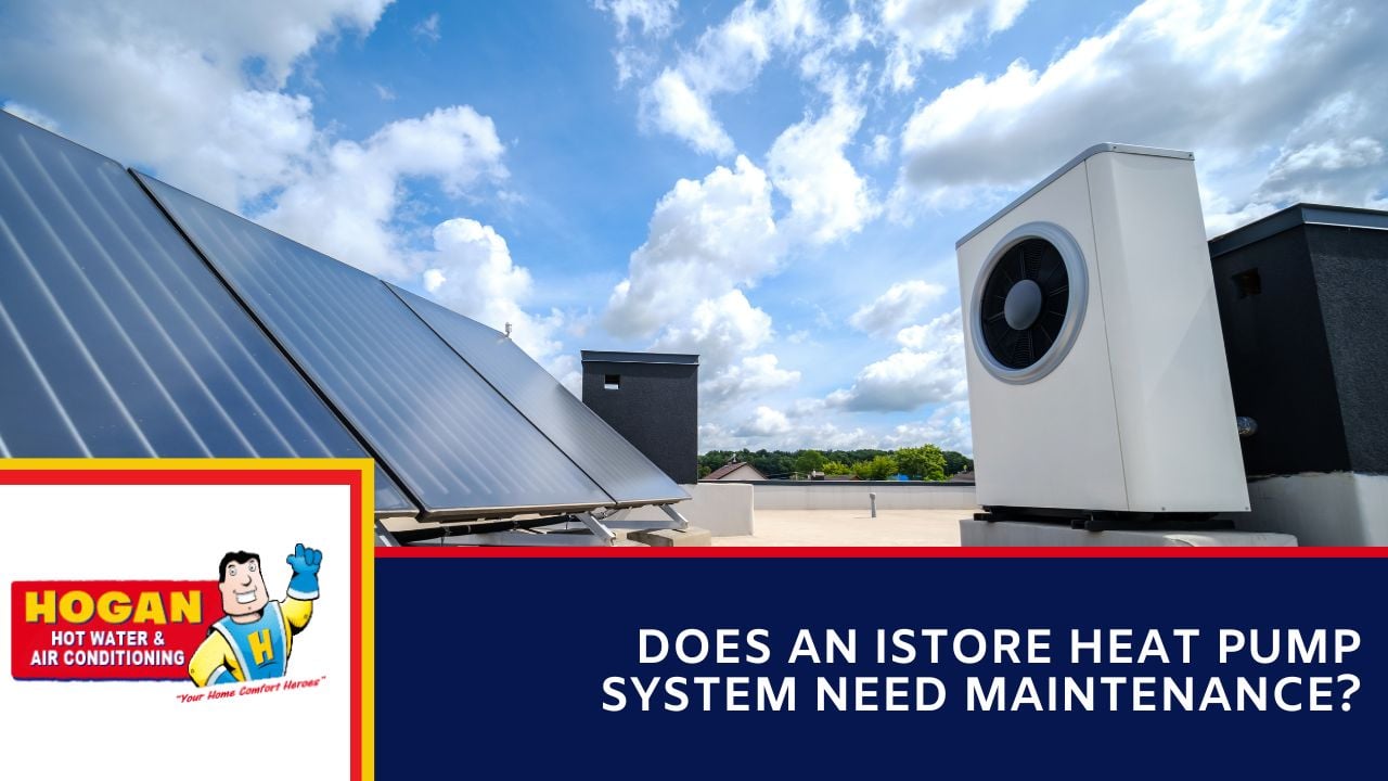 A flat rooftop with solar panels and an outdoor iStore heat pump unit