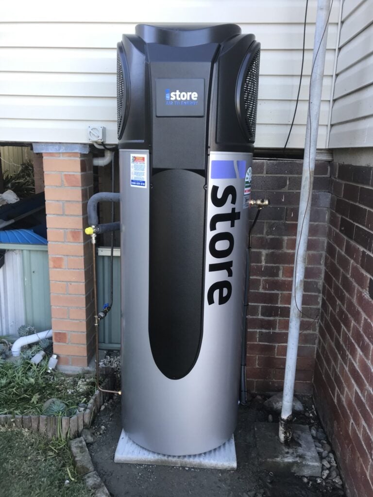 A silver iStore air-to-energy heat pump water heater with a black top fan unit.