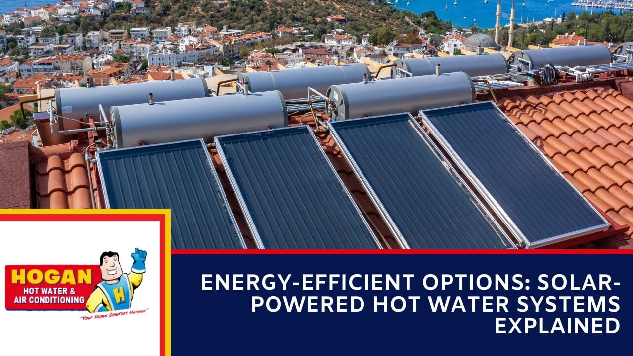 A multiple solar collector panels and storage tanks on a tiled roof overlooking a coastal town