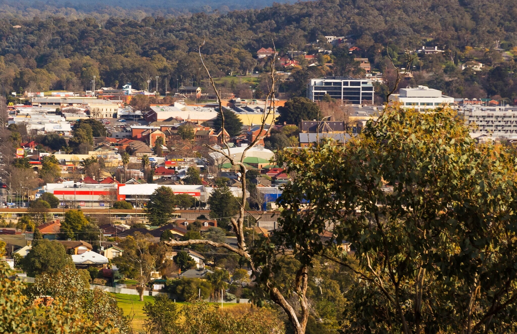 An elevated view of a suburban town nestled in a valley,