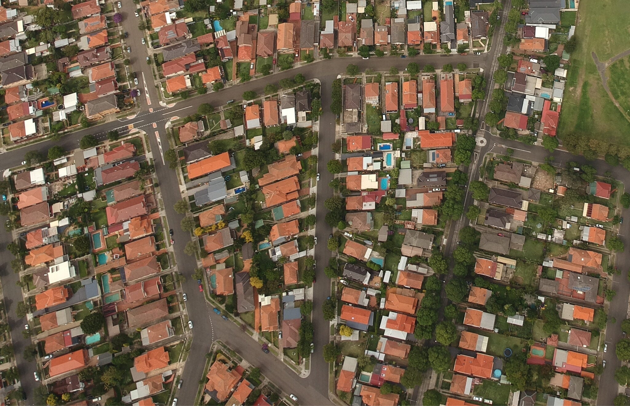 An aerial top-down view of a densely packed residential neighborhood