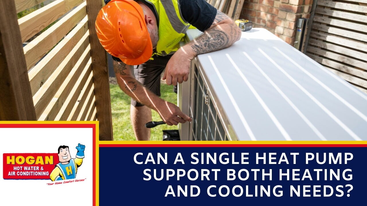 An HVAC worker wearing an orange hard hat and safety vest installing an outdoor heat pump system in a backyard.