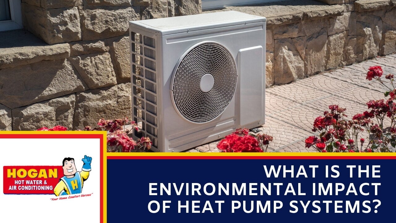 An outdoor heat pump compressor unit installed on a stone patio.