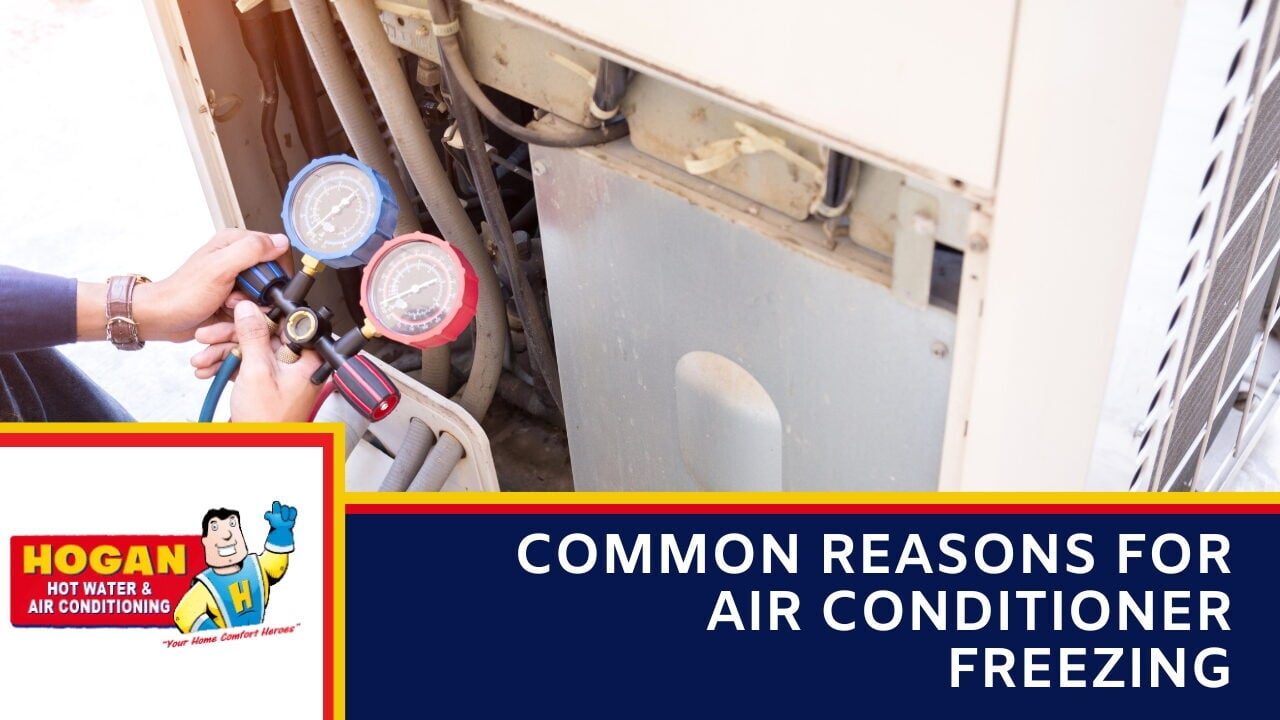 A technician uses a manifold gauge set to check an outdoor air conditioning unit.